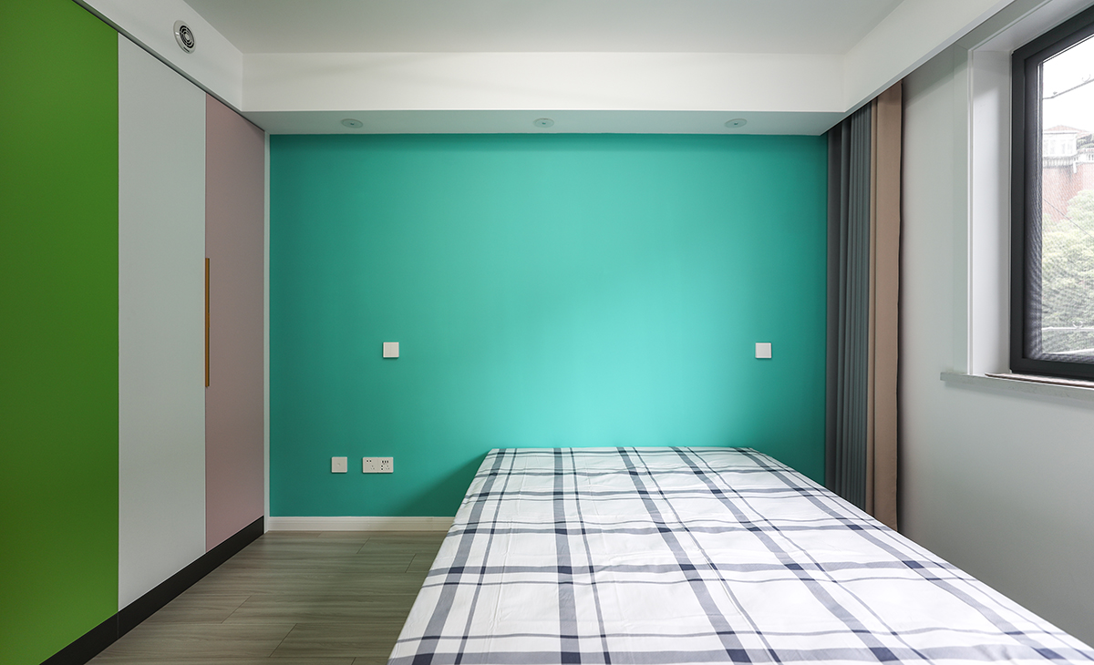 主卧床头背景用蓝绿色涂料装饰，白底灰条纹床单，咖色的窗帘，让卧室空间具有延伸感，无靠背的床让卧室显得更明亮、清爽。