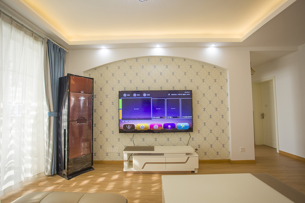 电视背景墙是家里面的视觉中心，这边是结合整体装修风格设计的，采用圆弧的造型体现简约大气的氛围。

