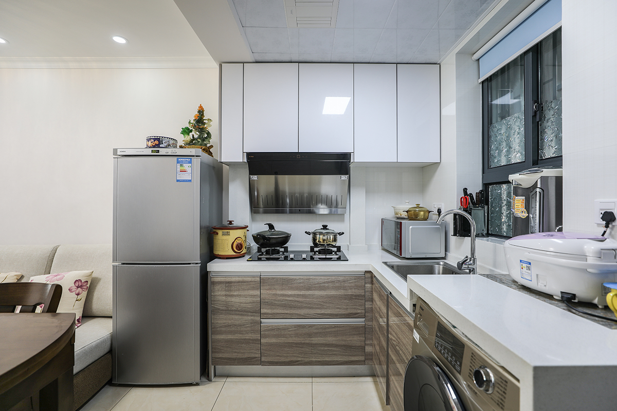 厨房间的设计风格采用了目前比较流行的亚克力板材，简约的同时又便于打理。白色的瓷砖搭配灰色系的橱柜，凸显了更多的层次。
